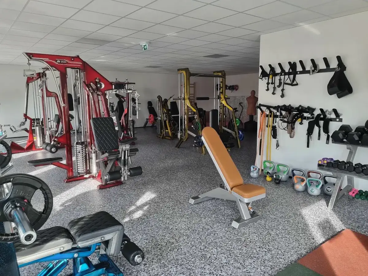 Plateau principal de la Salle de Musculation Gévaudan à Saugues, avec machines guidées rouges, banc réglable et kettlebells